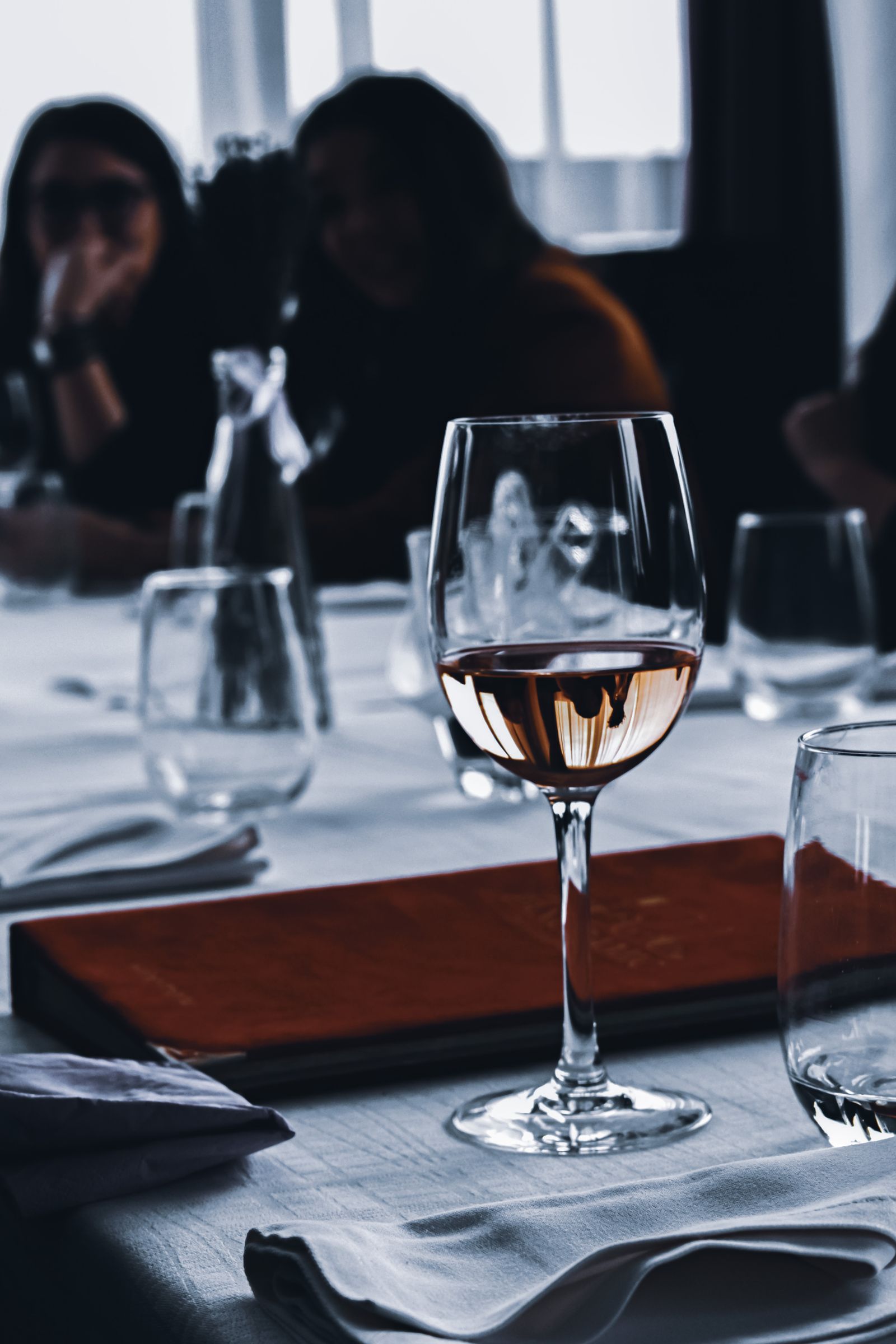 Calice di vino rosato su tavola apparecchiata